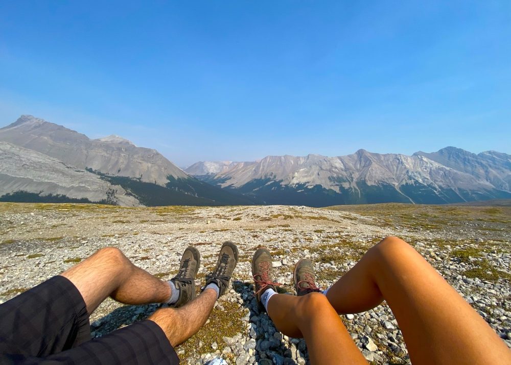 Sitting on top of a mountain in Jasper, Alberta with our legs stretched out